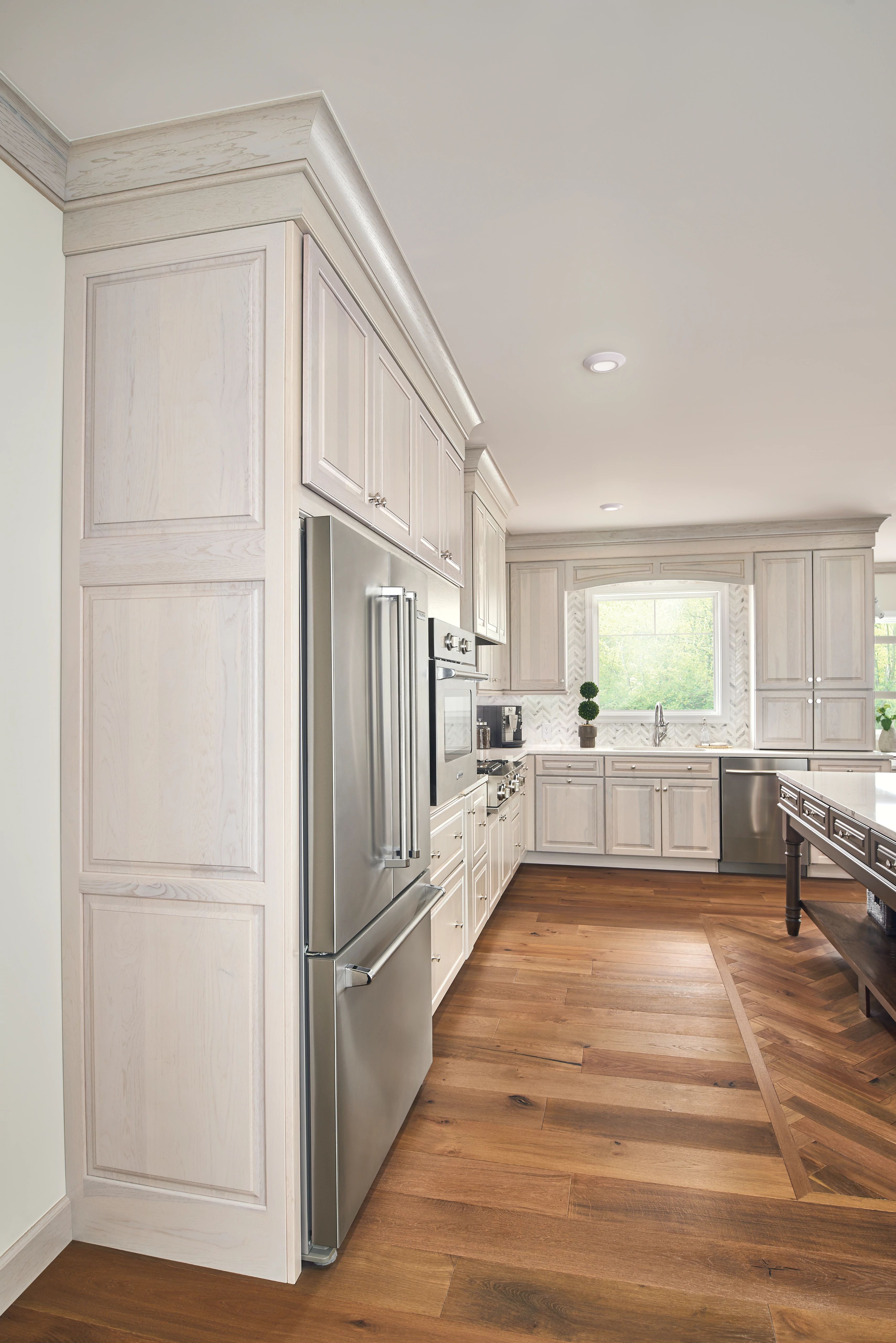 KraftMaid tall end panel used to create a built-in refrigerator look in a traditional kitchen