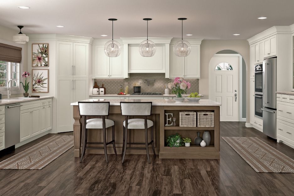 U-shaped KraftMaid kitchen layout with island featuring two-toned Warm White and Riverbed paint scheme