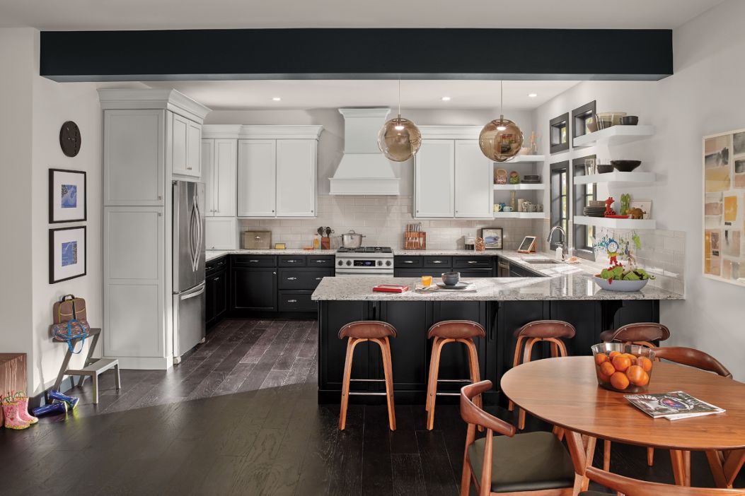 G-shaped KraftMaid kitchen layout with tuxedo-inspired cabinet color scheme in Onyx and Moonshine paint