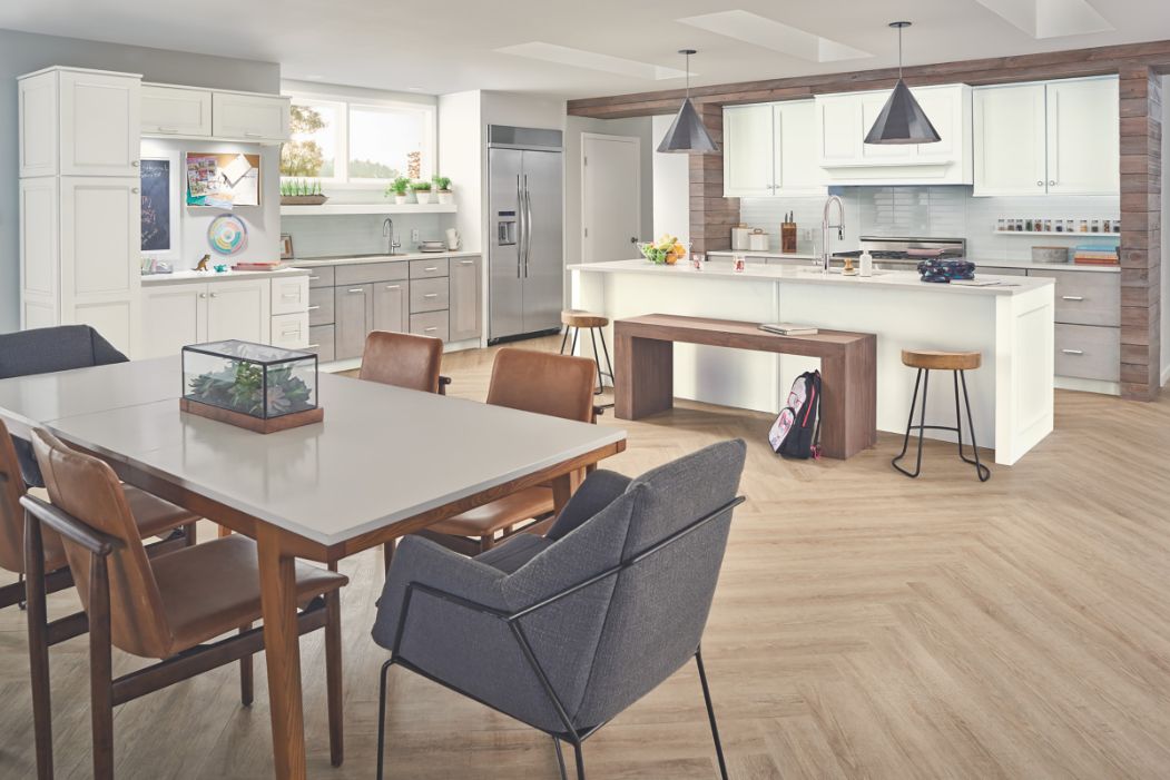 Contemporary, hygge-aesthetic kitchen design with KraftMaid cabinets in Dove White paint and Husk stain.