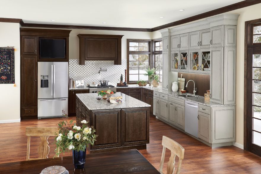 Traditional KraftMaid L-Shaped kitchen layout with raised-panel doors in Molasses stain and Aged Concrete finish