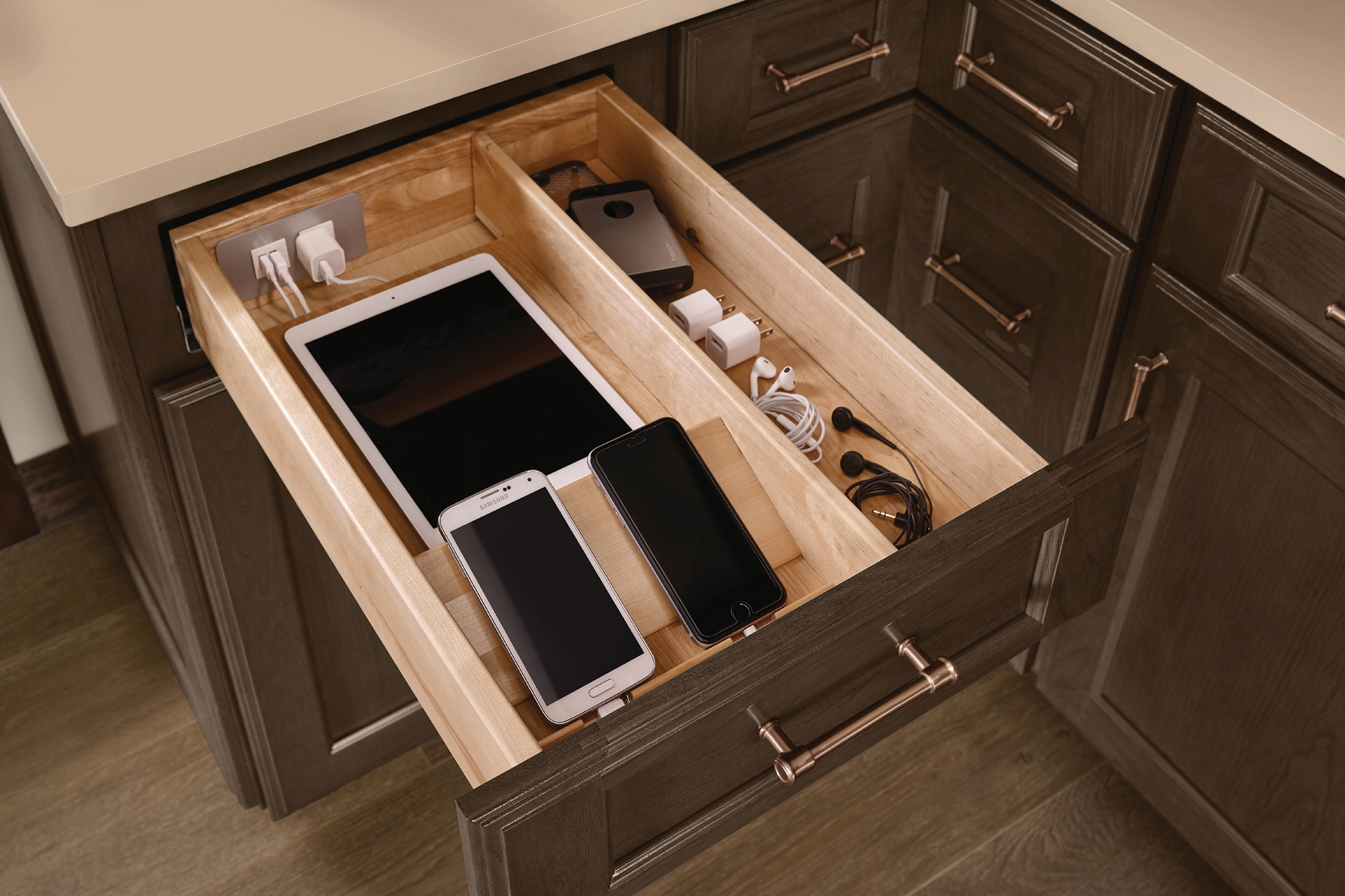 Charging station for phones and other smart devices hidden in the top drawer of a KraftMaid kitchen cabinet