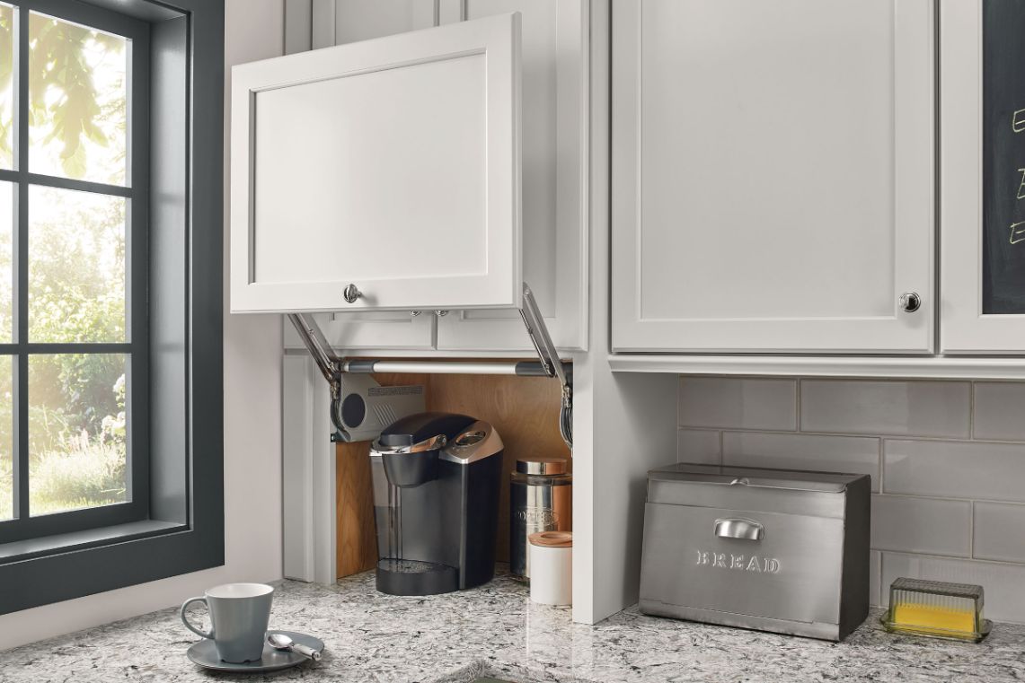 Coffee station in KraftMaid kitchen featuring appliance garage to store coffee maker