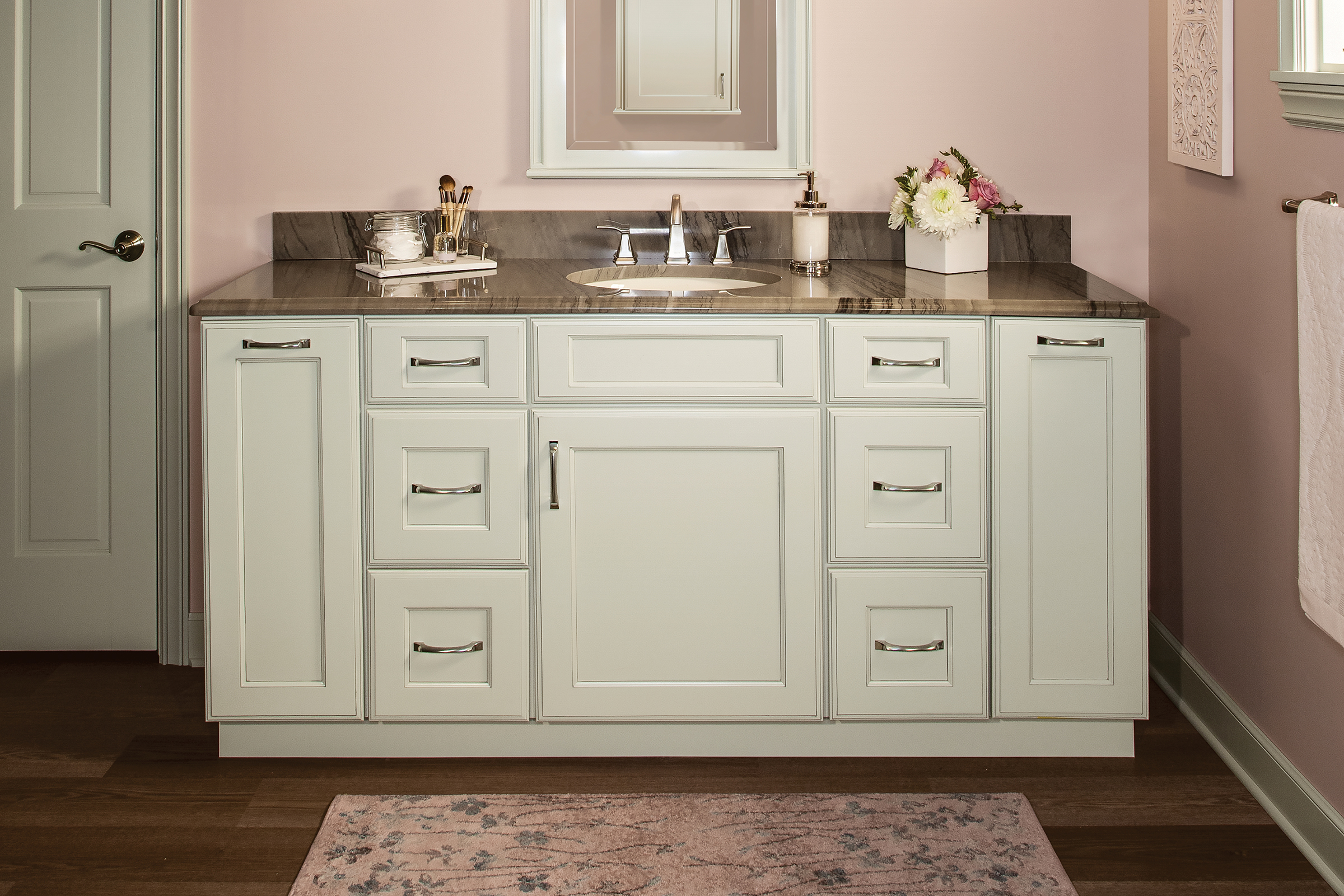 Glam bathroom with blush walls and KraftMaid vanity in Moonshine painted finish