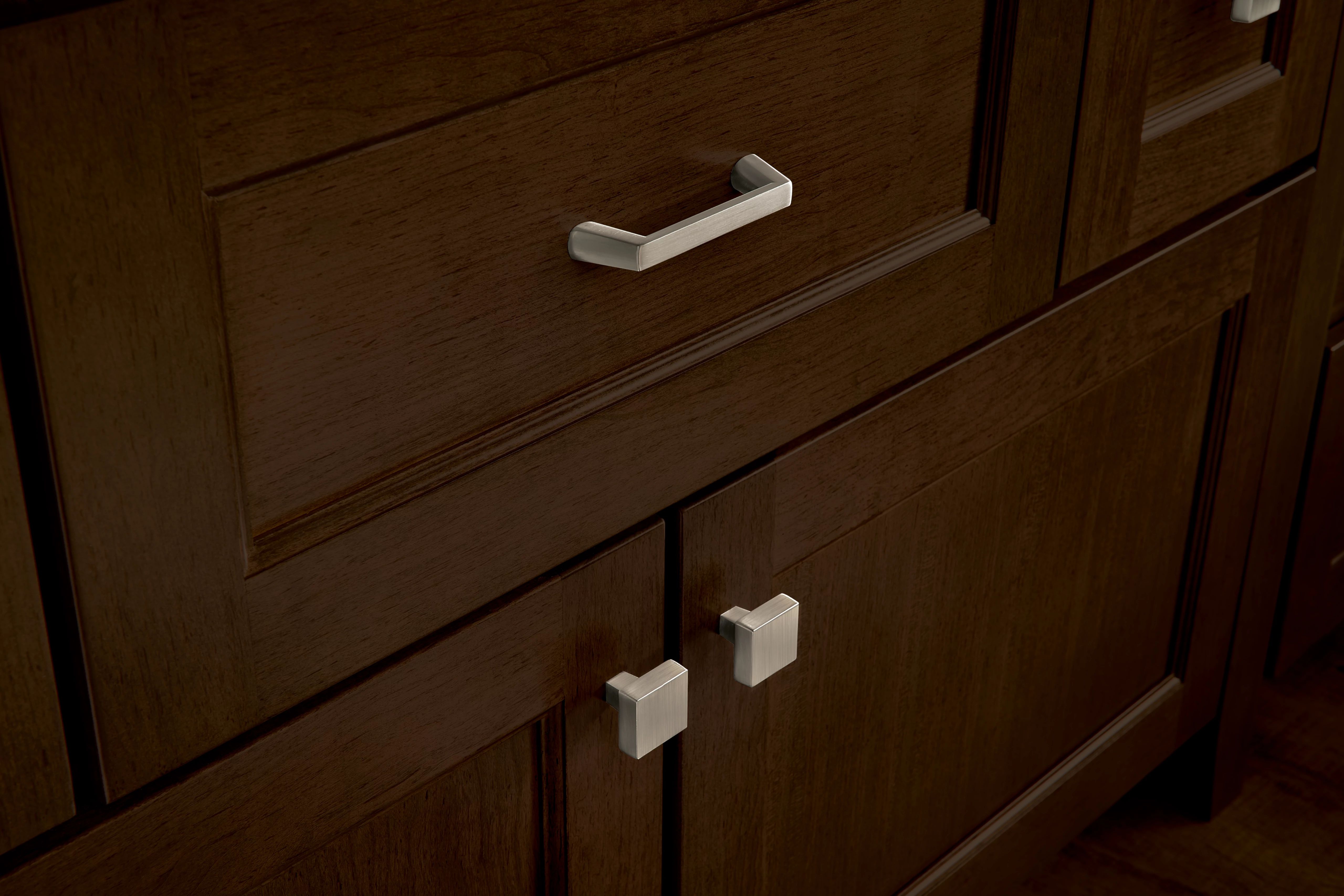 Use knobs and pulls from the same hardware collection for more visual variety in your kitchen design. 