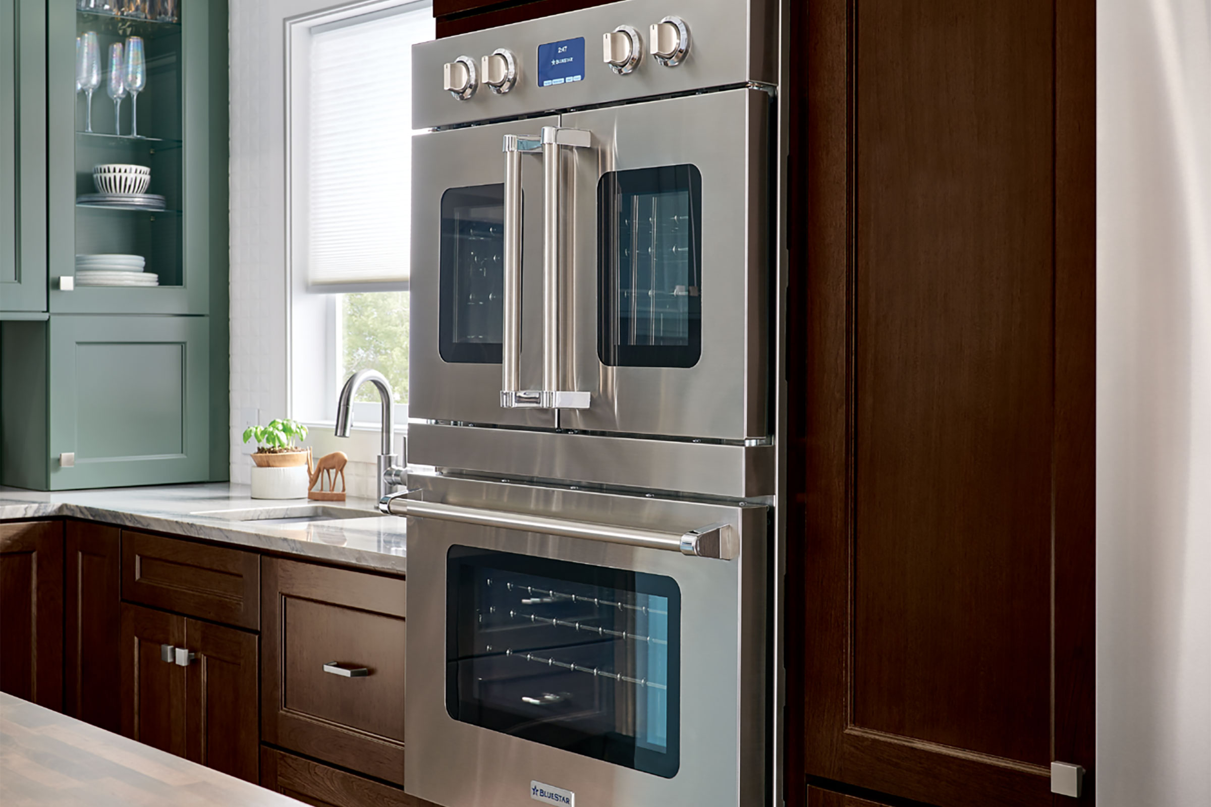 Dark-stained Cherry cabinets with professional-grade stainless steel appliances in a transitional-style kitchen featuring KraftMaid cabinetry