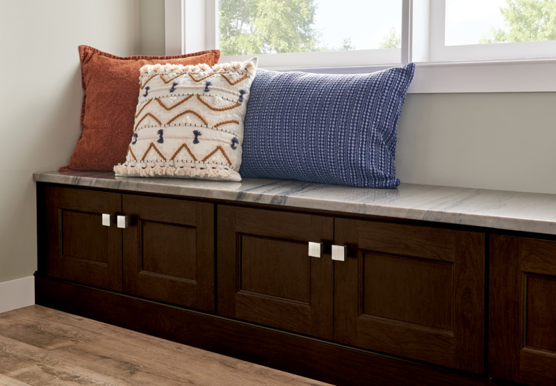 KraftMaid Pedestal Door Cabinets in Saddle stain used as banquettes for small kitchens 