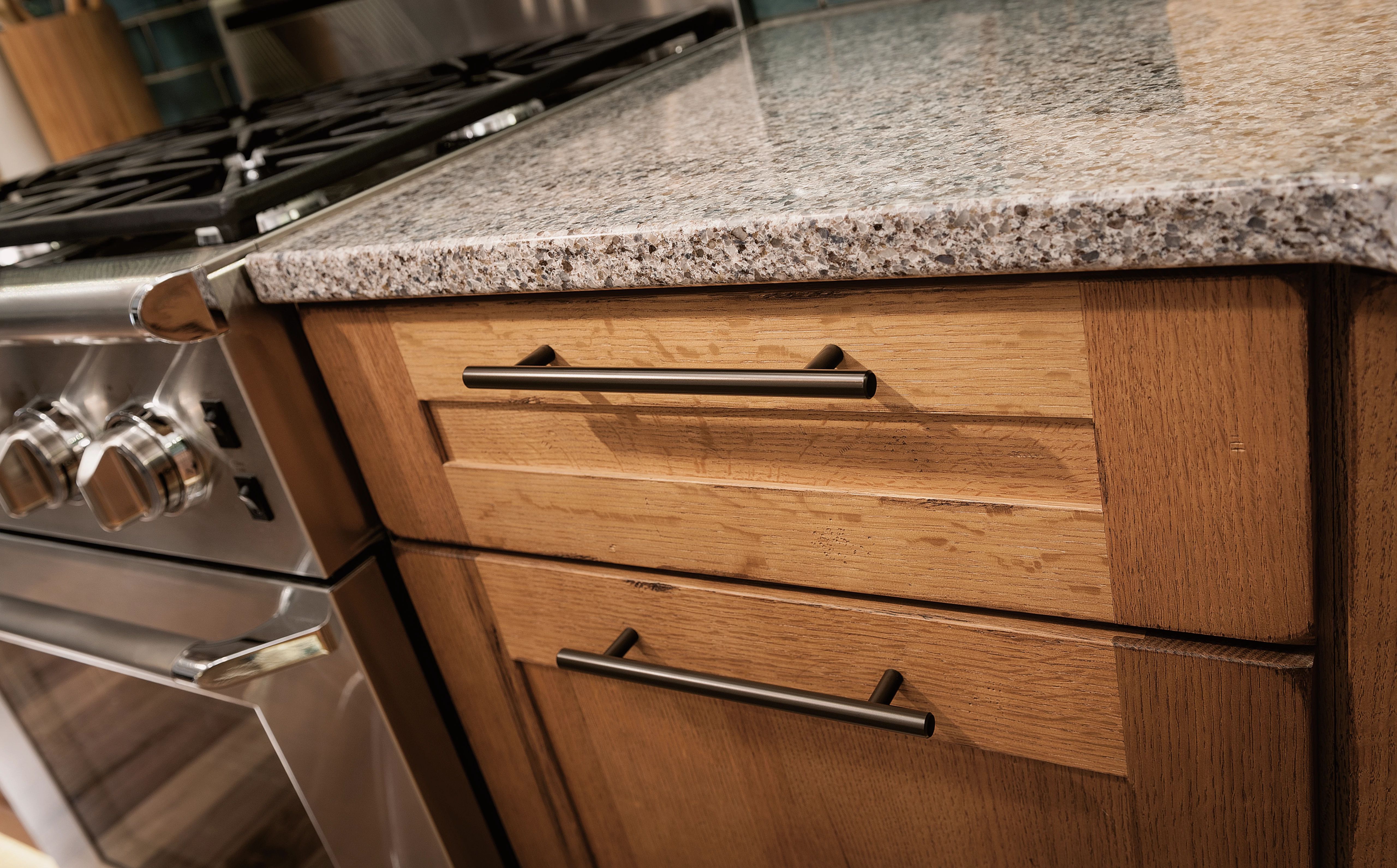 Oversized pulls with a Modern placement give cabinets a contemporary appearance.