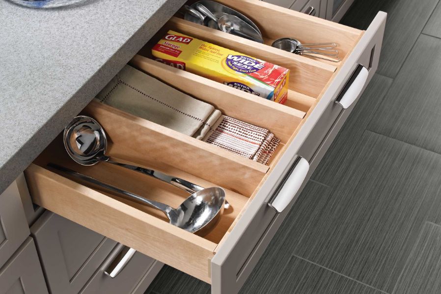 Clean kitchen drawers with KraftMaid Cabinetry dividers.