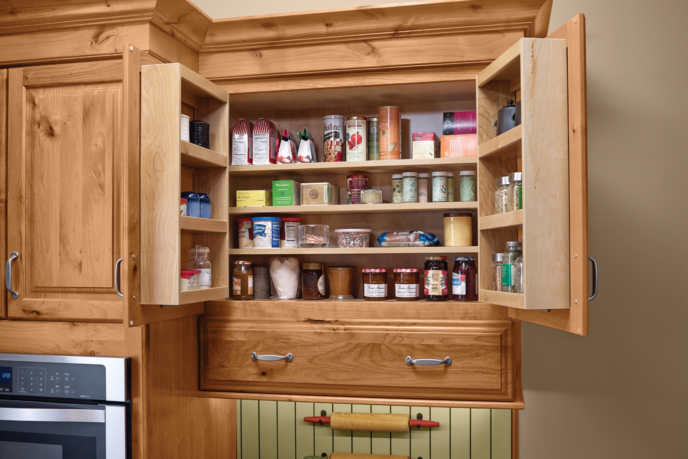 KraftMaid small pantry cabinet with adjustable interior shelves and pantry door storage racks mounted behind the doors